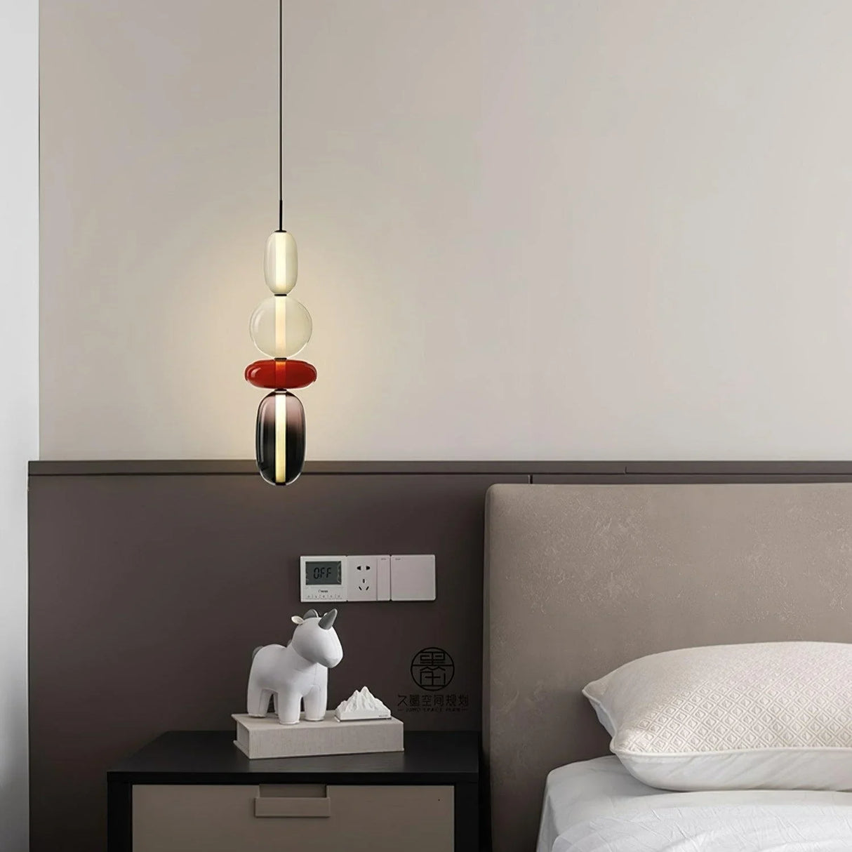 Modern glass pendant light design with elongated oval and disc jars