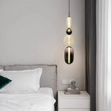 Stacked glass pendant light casting soft light in a modern interior scene