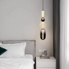 Stacked glass pendant light casting soft light in a modern interior scene