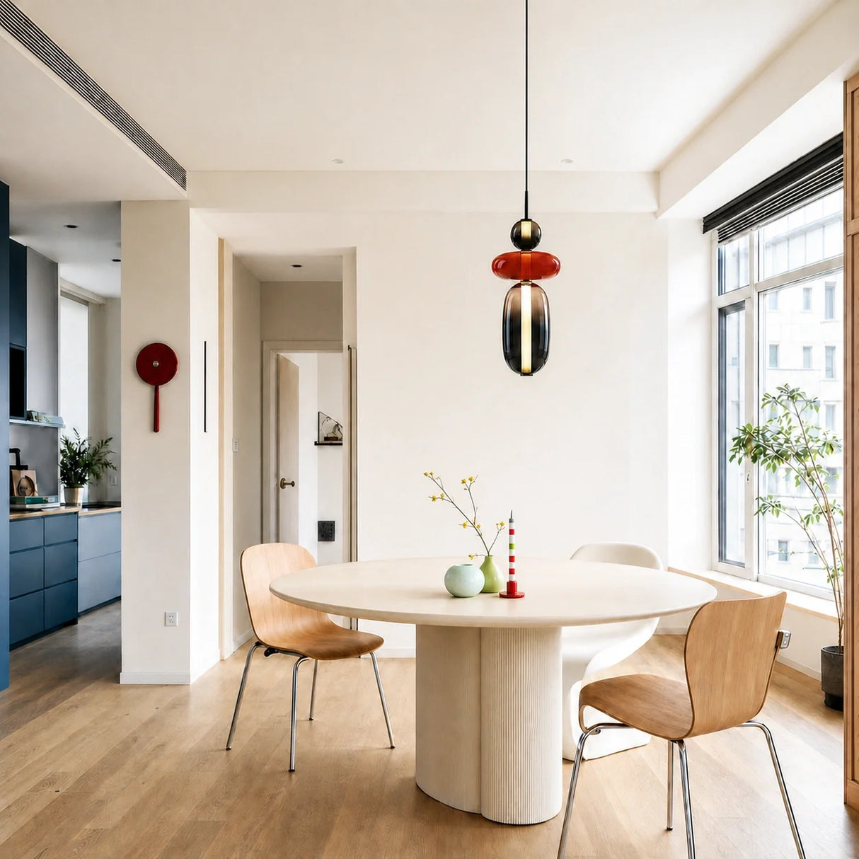 White globe and oval glass pendant light lit from within