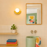 Colorful wall sconce showing the frosted globe seated on the base