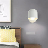 Green white yellow pink and grey macaron sconces grouped on a wall