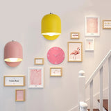 Grey macaron sconce lit above a bed with a whale print above