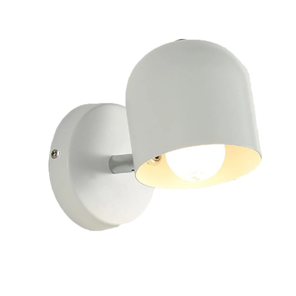 Pink macaron wall sconce on a plain grey studio background