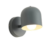 Macaron dome sconce turned to show the tilting stem joint