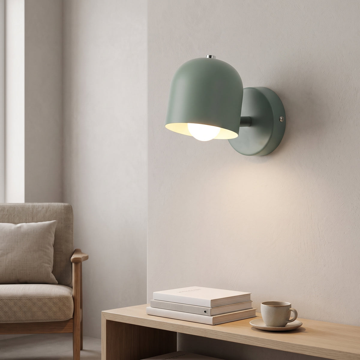 Green macaron wall sconce lit beside a chair and side table