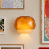 Coloured glass wall sconce viewed from a front angle unlit