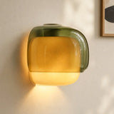 Coloured glass wall sconce mounted in a warm minimalist interior setting