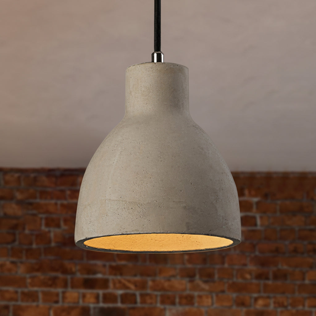 Cement barn pendant lit in front of a red brick wall