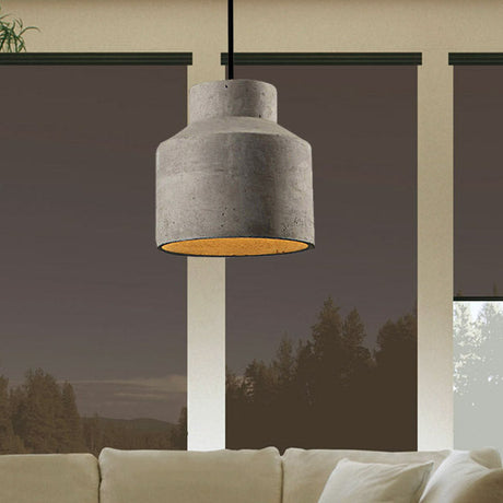 Cylinder cement pendant hanging by a window with a forest view