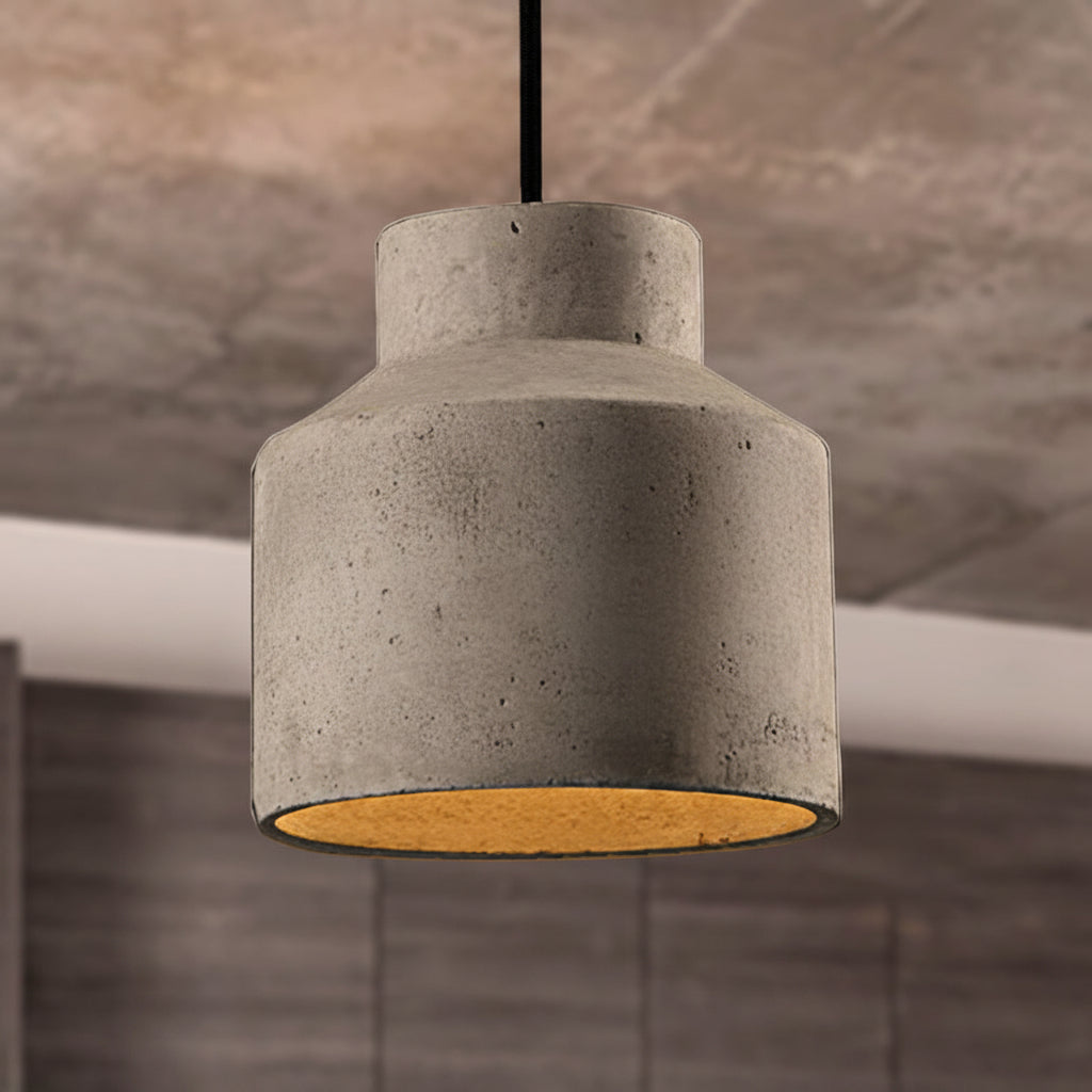 Stepped cylinder cement pendant against a warm marbled stone wall