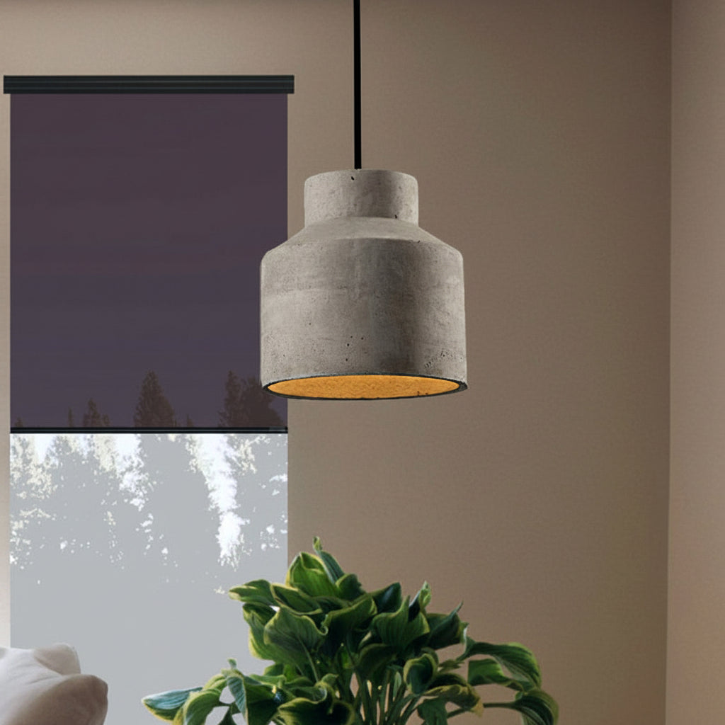 Cylinder cement pendant beside a window with a dark blind