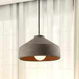 Wide cement dome pendant lit beside sheer white curtains