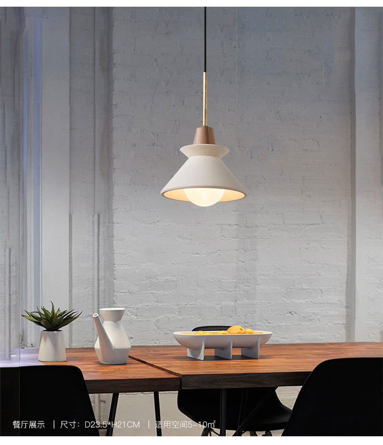 Cement cone pendant above a dining table in a bright loft