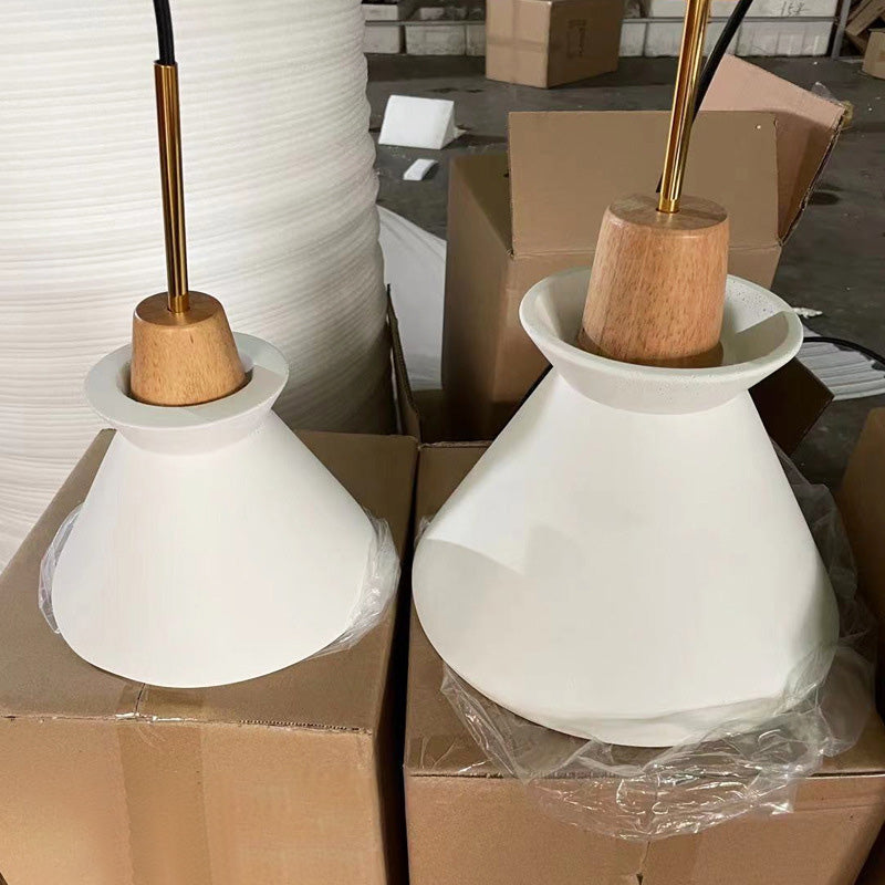 Two unlit cement shades resting in packing cartons at the warehouse