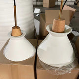 Two unlit cement shades resting in packing cartons at the warehouse