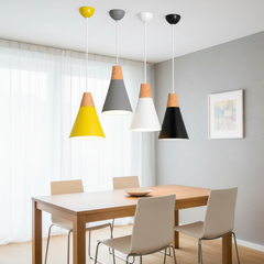 Four cone pendants in yellow, grey, white and black on a ceiling