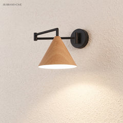 Cone shade swing arm wall sconce on a textured wall