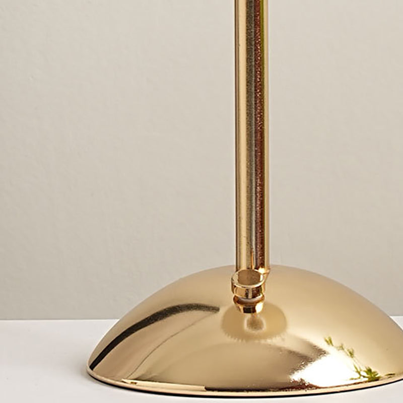 Close-up of the gold domed base and small control knob on the stem