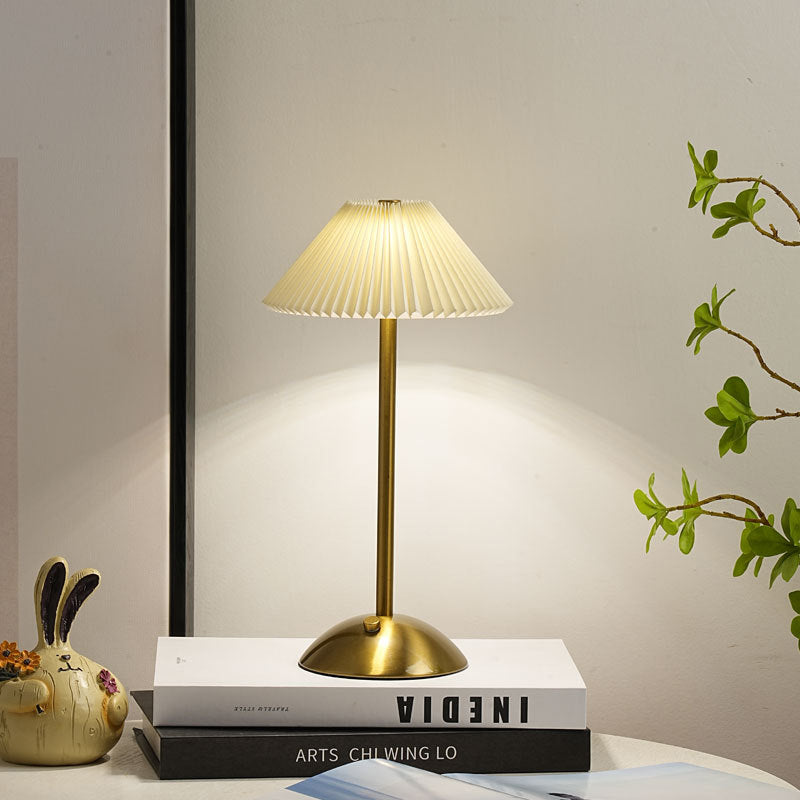 Side view of the gold table lamp and pleated fabric conic shade