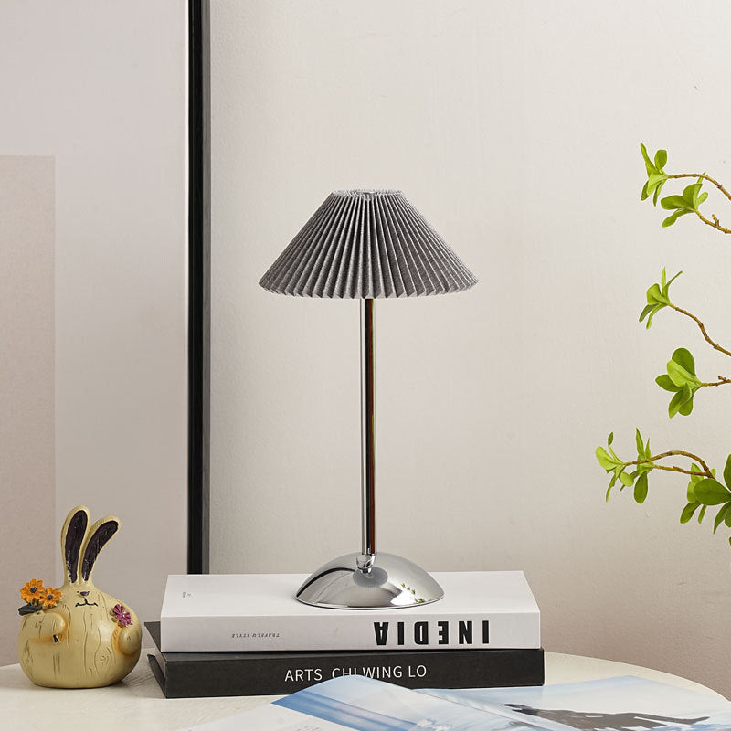 Grey pleated shade on a chrome silver base table lamp