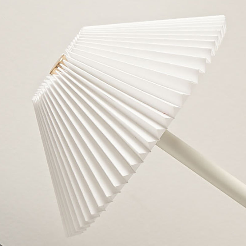 Slim polished stem meeting the low domed base of the table lamp