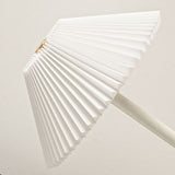 Slim polished stem meeting the low domed base of the table lamp