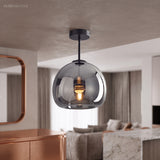 Smoke glass semi flush light in a bedroom with a copper framed mirror