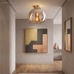 Amber glass semi flush light in a hallway with framed artwork