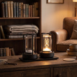 Two rechargeable lamps in black and silver on a sideboard by a bookcase