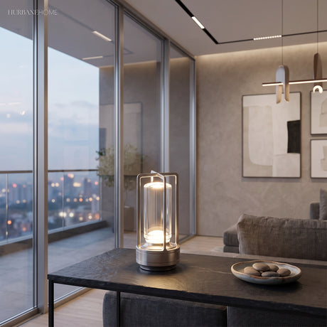 Black cordless lamp on a low table in a glass walled apartment at dusk
