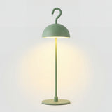 Green cordless LED table lamp with metal dome shade and hook top on round base