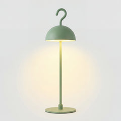 Green cordless LED table lamp with metal dome shade and hook top on round base