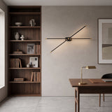 Slim brass linear wall light lit above a gold and blue abstract canvas