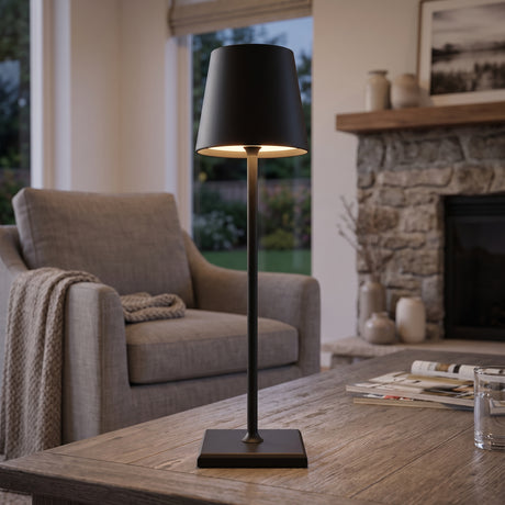 Black cordless table lamp on a wooden table in a living room