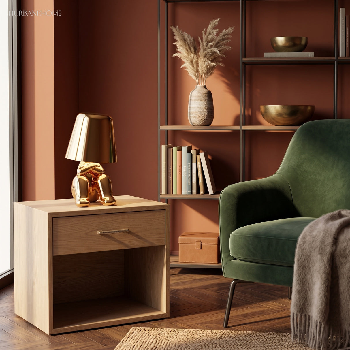 Gold figurine lamp lit on a bedside cabinet in a terracotta room