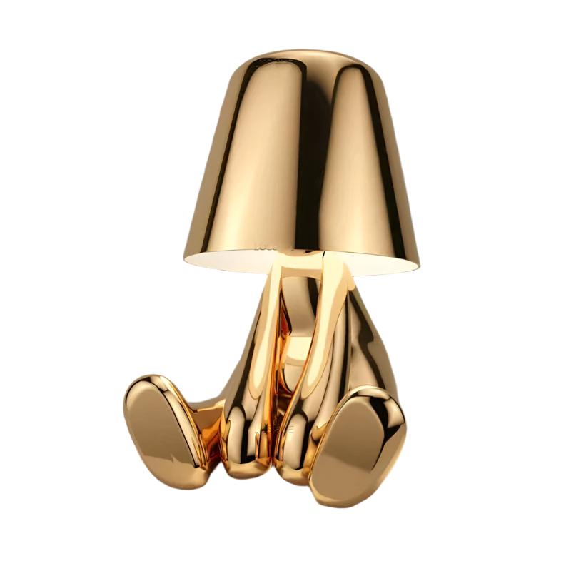 Gold figurine lamp seated with its legs stretched out in front