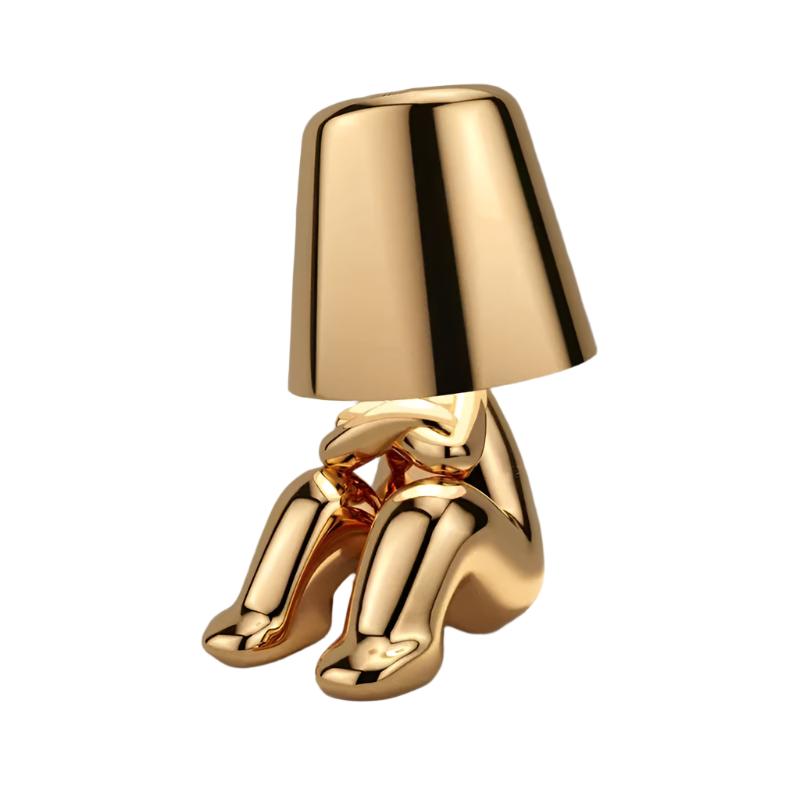 Gold figurine lamp crouching with its knees drawn up