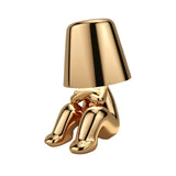 Gold figurine lamp crouching with its knees drawn up