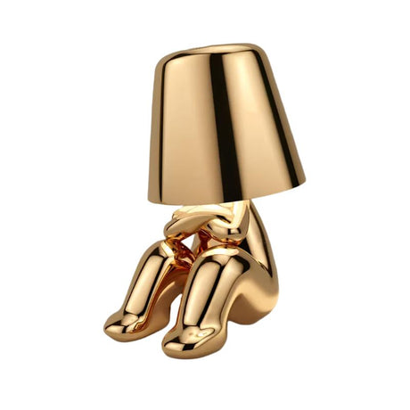 Gold figurine lamp crouching with its knees drawn up