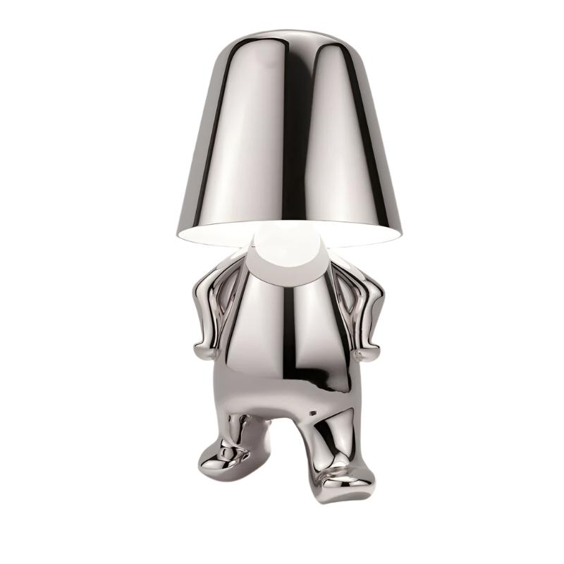 Silver figurine lamp standing upright holding the shade overhead