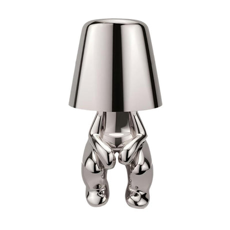 Silver figurine lamp standing to attention beneath the tapered shade