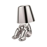Silver figurine lamp crouching with its knees drawn up