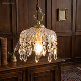 Vintage crystal pendant light over a table in a panelled room