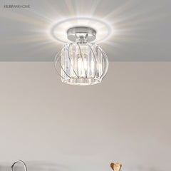 Chrome finish crystal cage ceiling light casting a bright ring of light