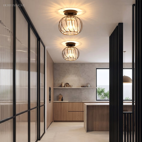 Two crystal cage ceiling lights along a hallway beside a timber kitchen