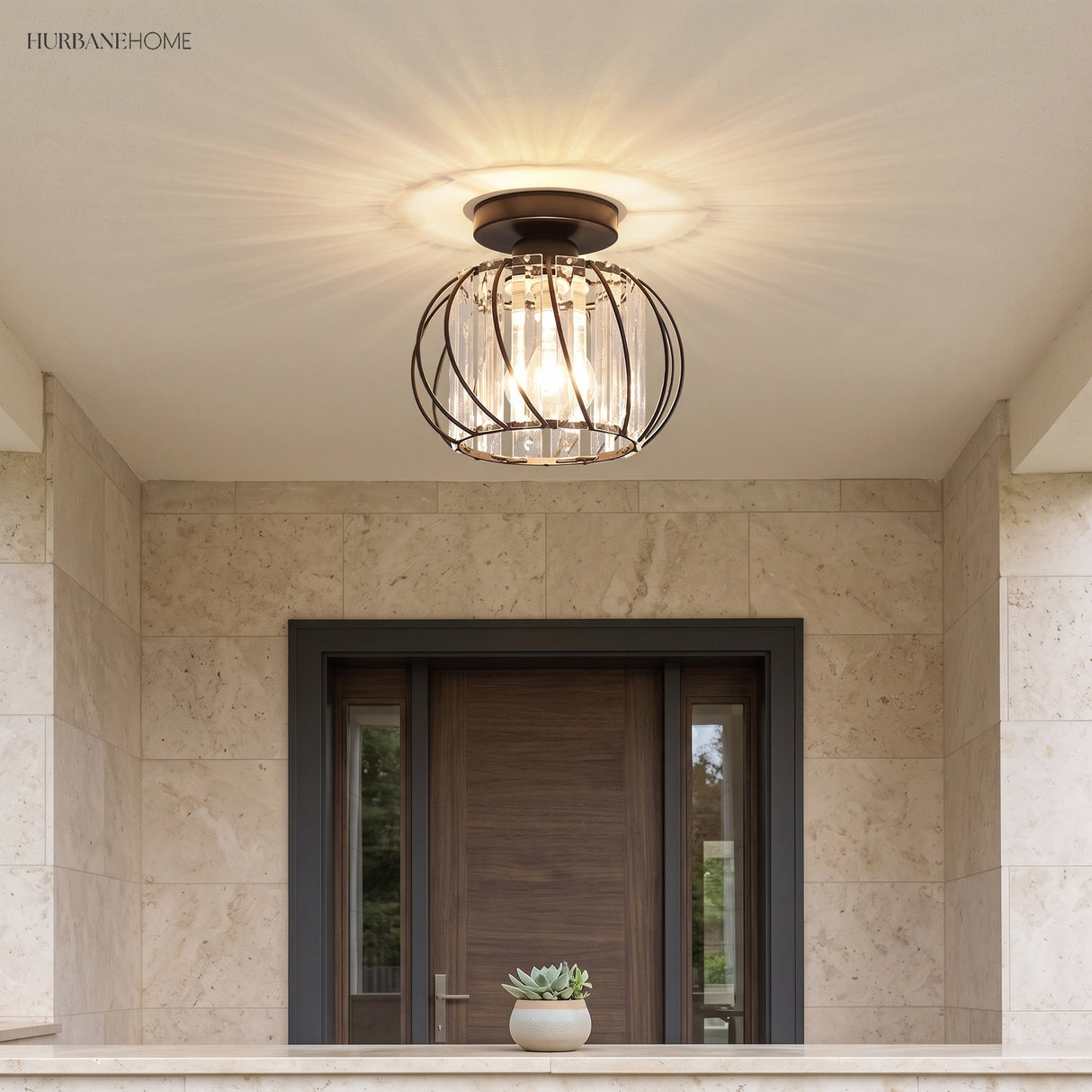 Crystal cage ceiling light above a stone clad entry with a timber front door