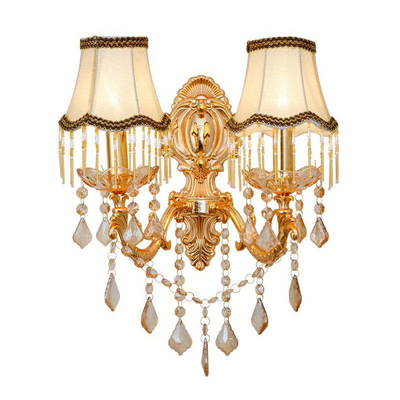 Cut out view of the gold sconce with pleated shades and crystals