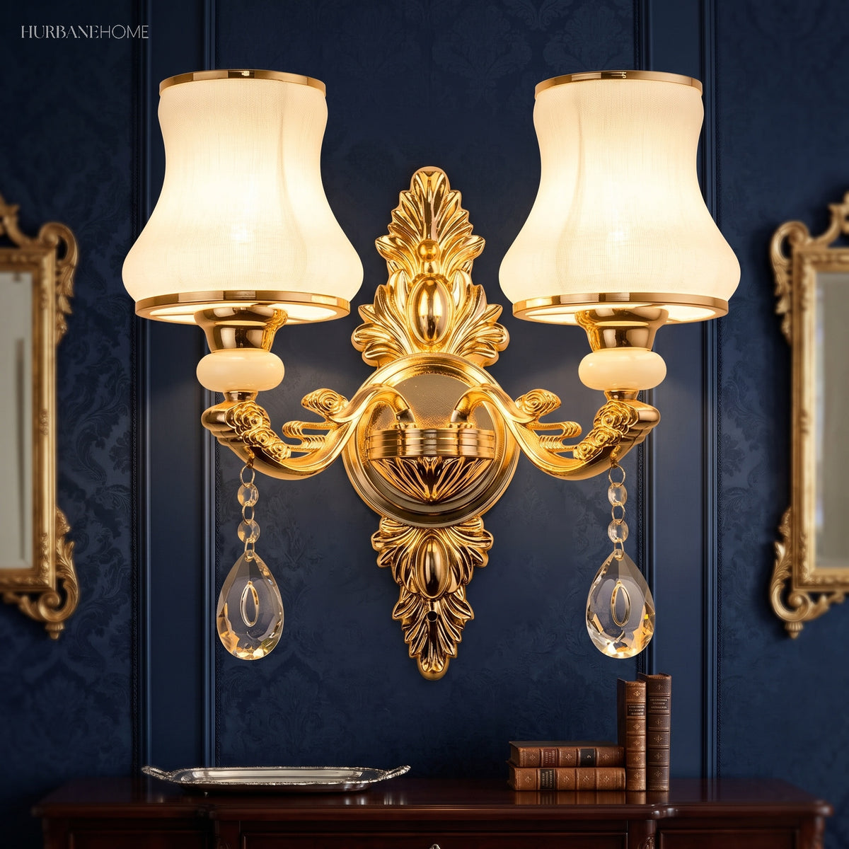 Gold two light sconce with opal glass shades beside a wall mirror