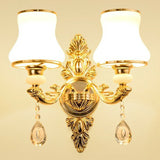 Gold two light sconce with rounded opal glass gourd shades